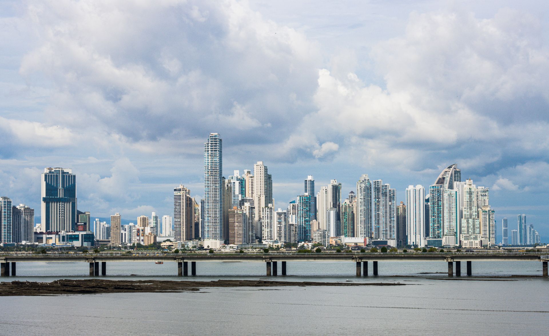Panama City skyline and bridge beneath a broad sky